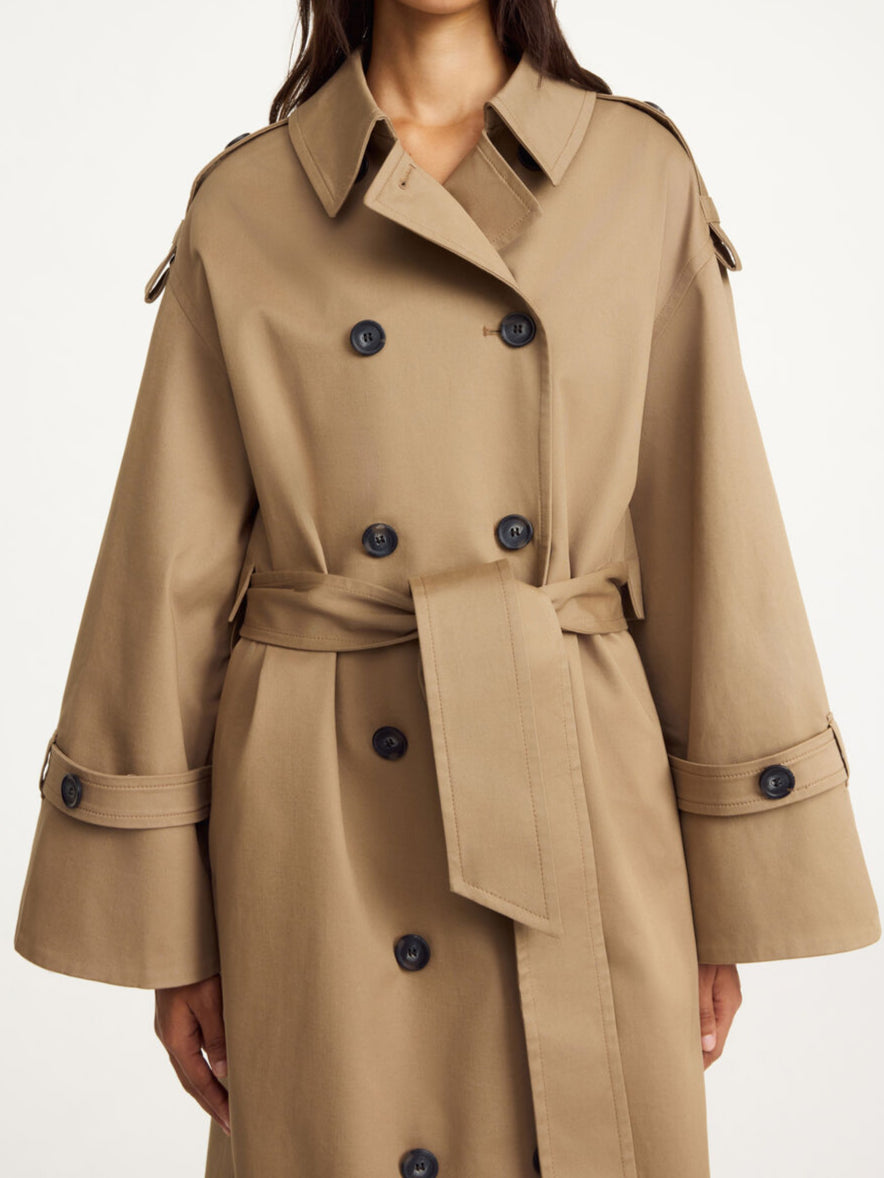 By Malene Birger Alaya trenchcoat i brun, med et oversized uttrykk og en blanding av organisk bomull og elastan.