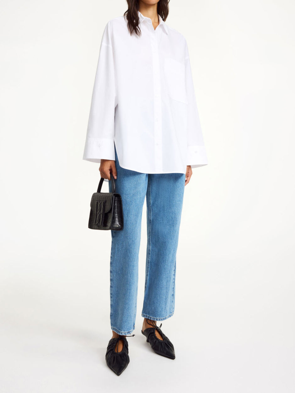 By Malene Birger Derris bomullskjorte i hvit, med en oversized passform og brystlomme, laget av 100% organisk bomull.