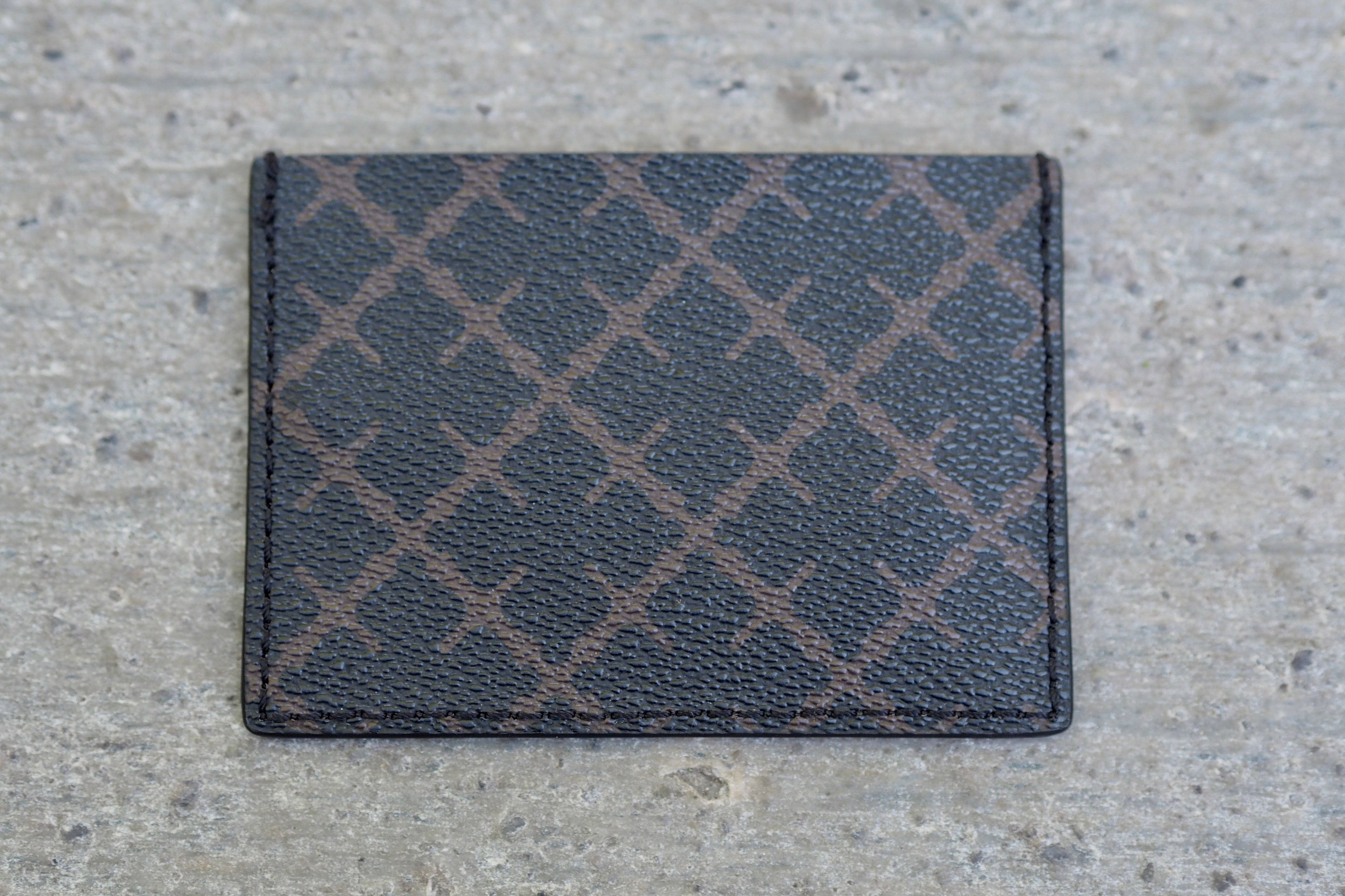 By Malene Birger Elia Card kortholder i brun, laget av 100% polyvinylklorid, med Signature Flower-print og plass til flere kort.