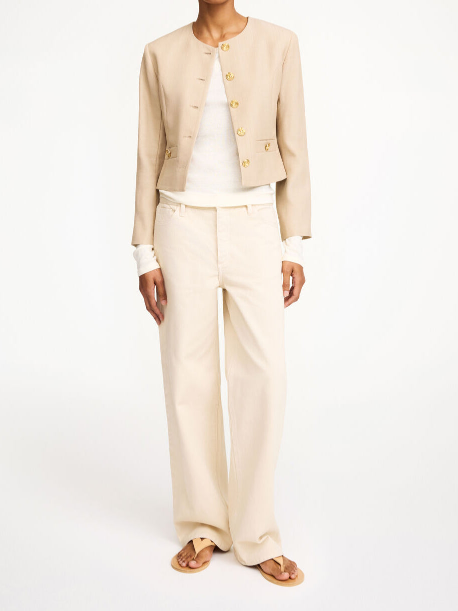 By Malene Birger Frida blazer i beige, med en feminin og nett passform, gullknapper og cropped lengde.