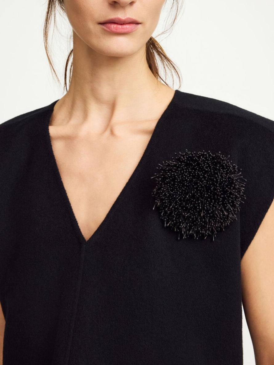 By Malene Birger Henna brosje i sort, inspirert av Anemone-blomsten, med både nål- og klypelukking, laget av 100% polyester.