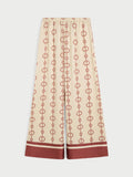 LUNIA bukse fra By Malene Birger med egenutviklet print, laget i 85% acetat og 15% polyester. Høyt liv, strikk i livet, vide ben og lommer i siden.