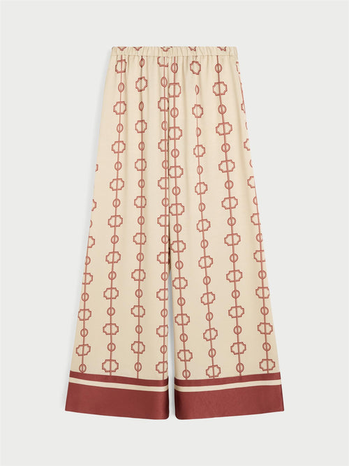 LUNIA bukse fra By Malene Birger med egenutviklet print, laget i 85% acetat og 15% polyester. Høyt liv, strikk i livet, vide ben og lommer i siden.
