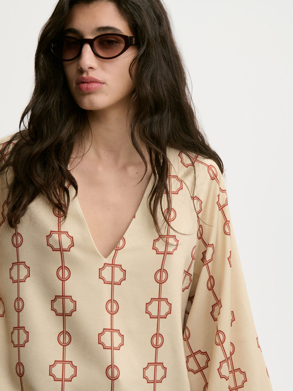SALIA bluse fra By Malene Birger med egenutviklet print, laget i 85% acetat og 15% polyester. Raglanermer med ballongfasong, v-hals og strikk i mansjettene.