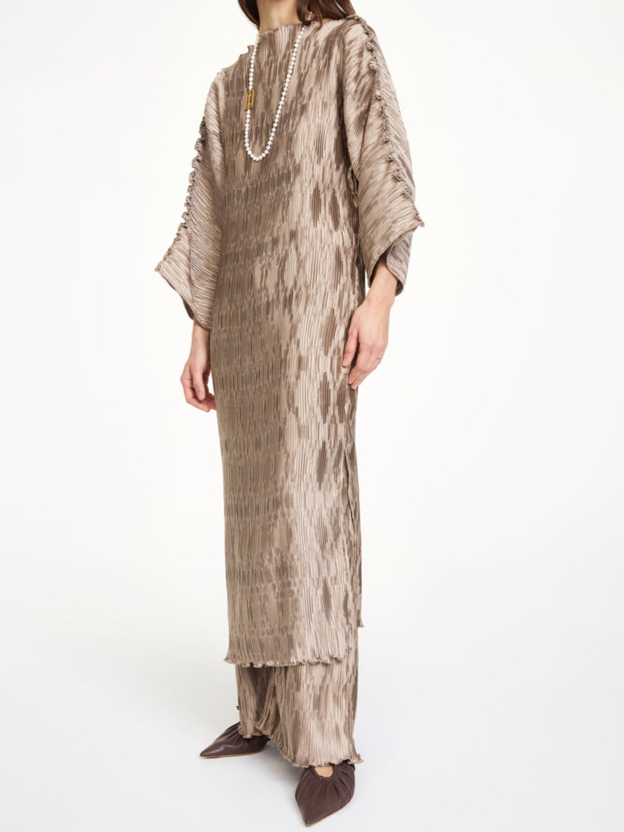 By Malene Birger Tralaido kjole i beige, med plissé struktur, båtutringning og vide ermer, laget av resirkulert polyester.