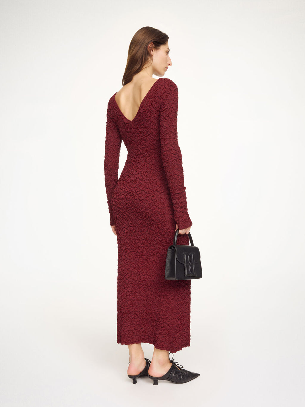 By Malene Birger Venus lang kjole i burgunder viskose med rund hals, v-rygg, lange ermer og smal passform.