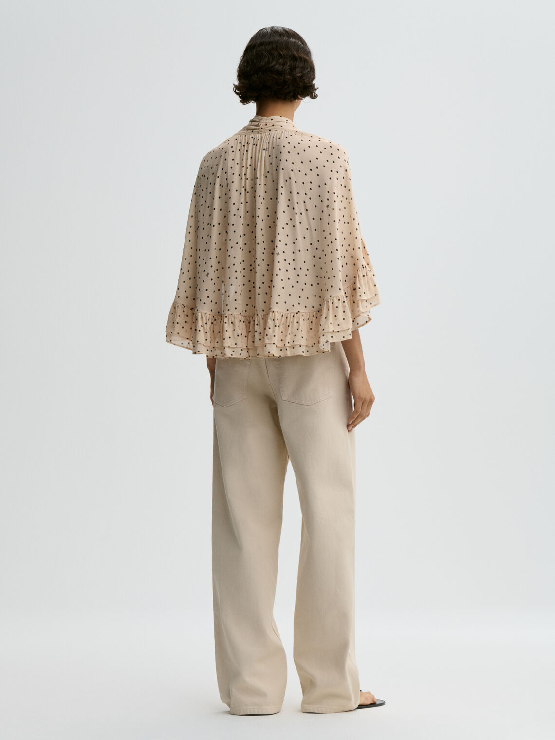 By Malene Birger CEDI cape med prikkete monogram-print. Lett og elegant materiale med rund halsringning og fallende linjer.
