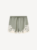 By Malene Birger ERI sateng shorts i olivengrønn acetat med blonde-detaljer langs kanten, elastisk linning og lommer i siden.